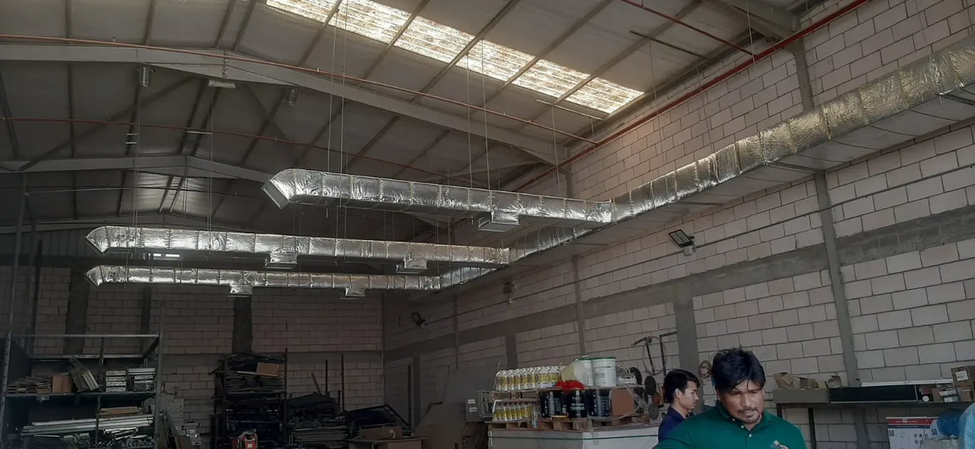Long run of installed ductwork across a warehouse ceiling