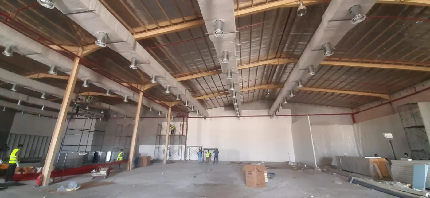 Ductwork installed along the roof structure of an open hall